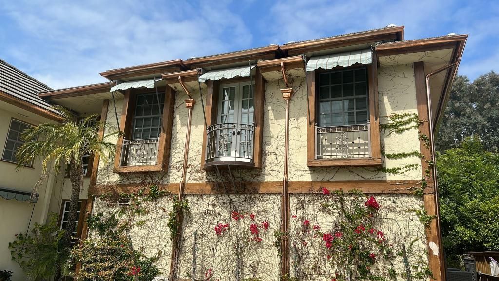 A brown roof with a skylight on it