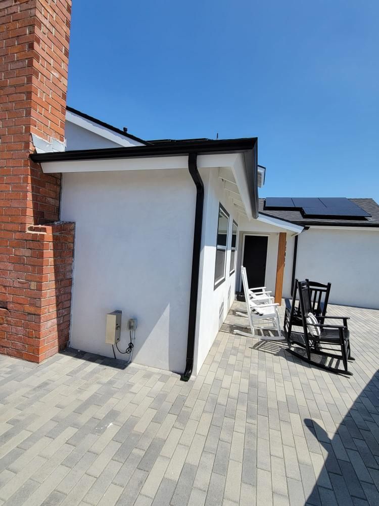 An aerial view of a house with a porch and a roof