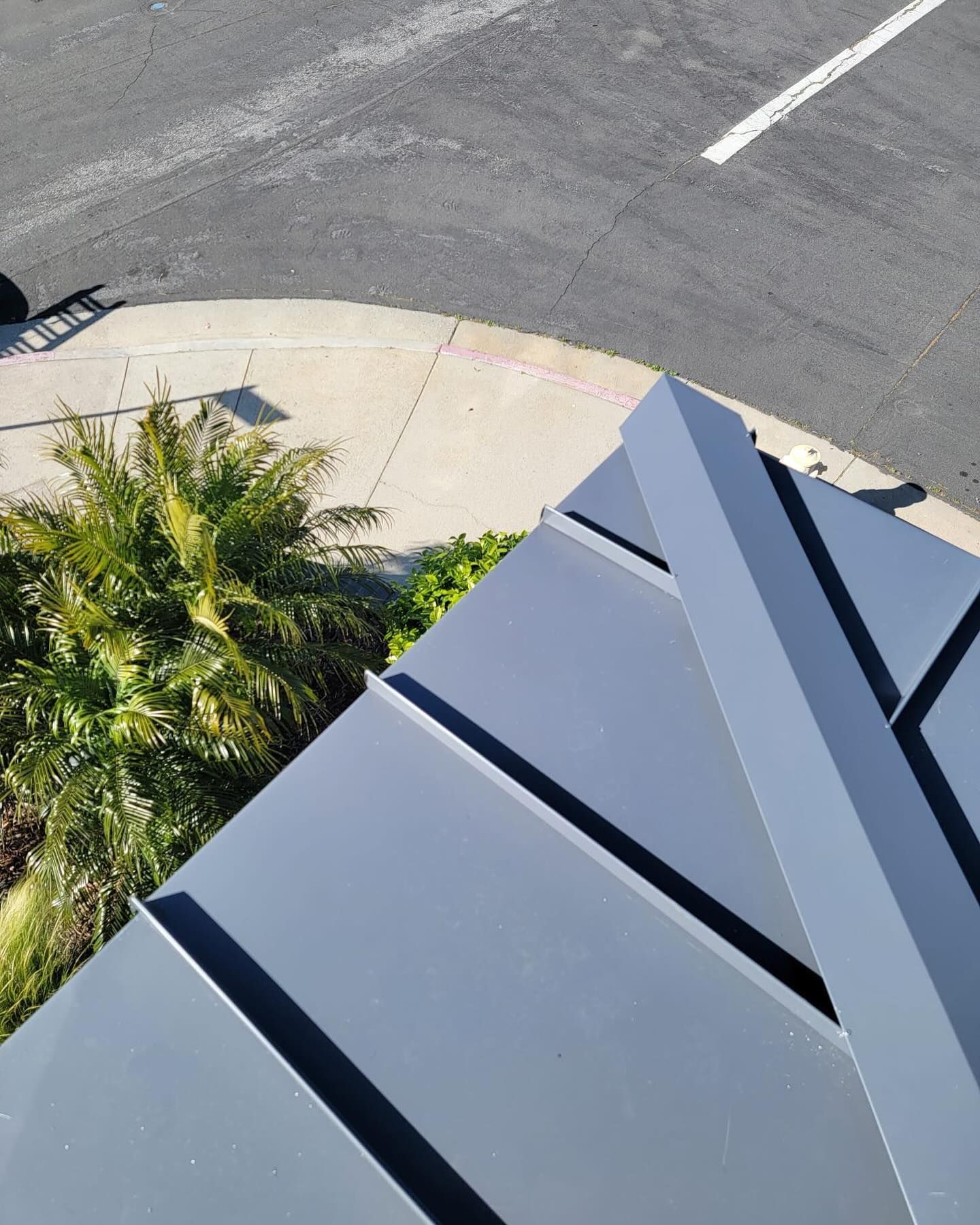 An aerial view of a building with a palm tree in the background