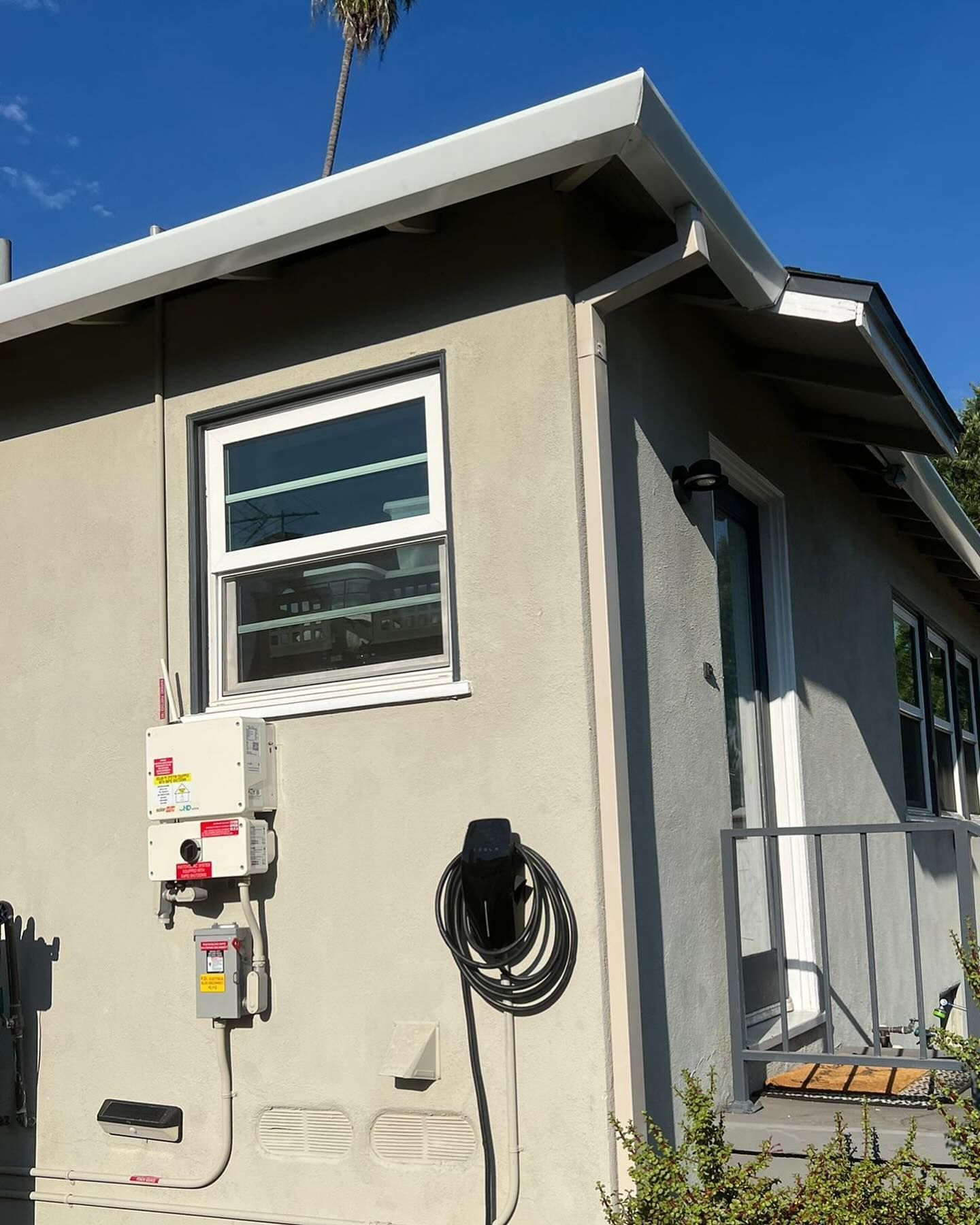 A house with a hose hanging from the side of it
