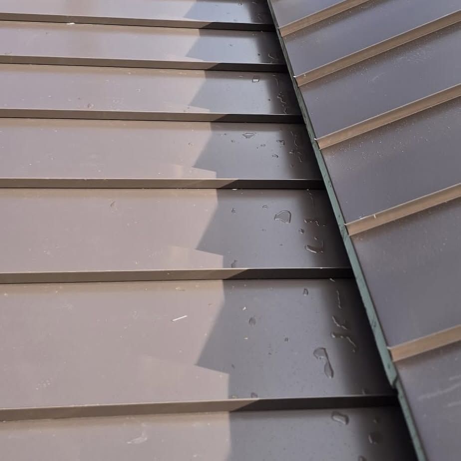 A close up of a roof with water drops on it