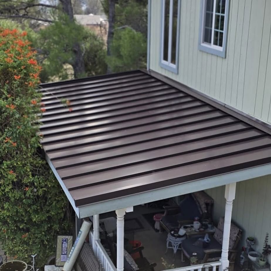 An aerial view of a house with a porch and a roof