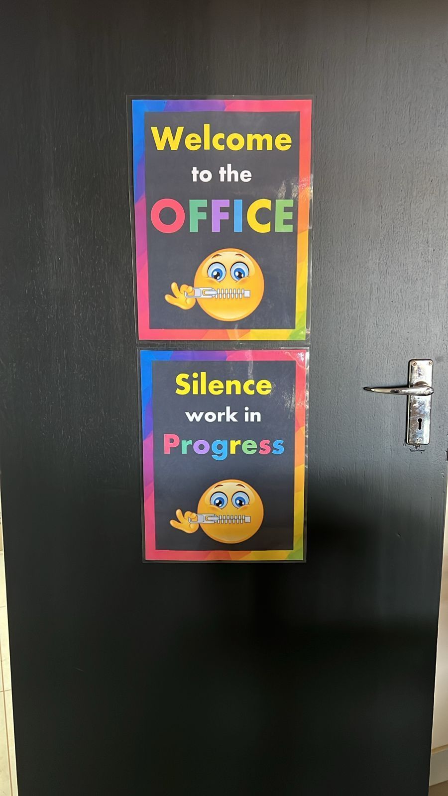 A door with two posters on it that say welcome to the office and silence work in progress.