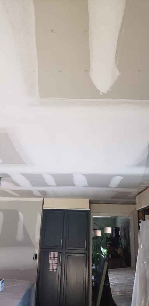Ceiling and cabinets being constructed in a kitchen.