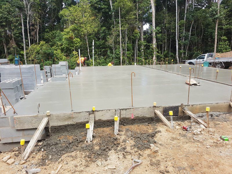 A Concrete Floor Is Being Built In The Middle Of A Forest — B & C Donnachie Concrete Contractors in Atherton, QLD