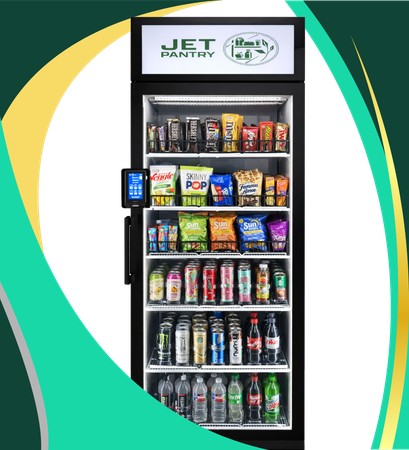A black Jet Pantry vending machine filled with various snacks and bottled beverages on its interior shelves.
