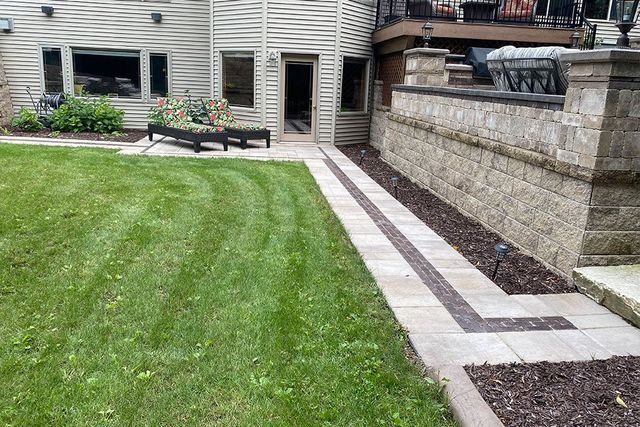 A Walkway Leading To A Patio In The Backyard Of A House — Menasha, WI — Artscapes COC