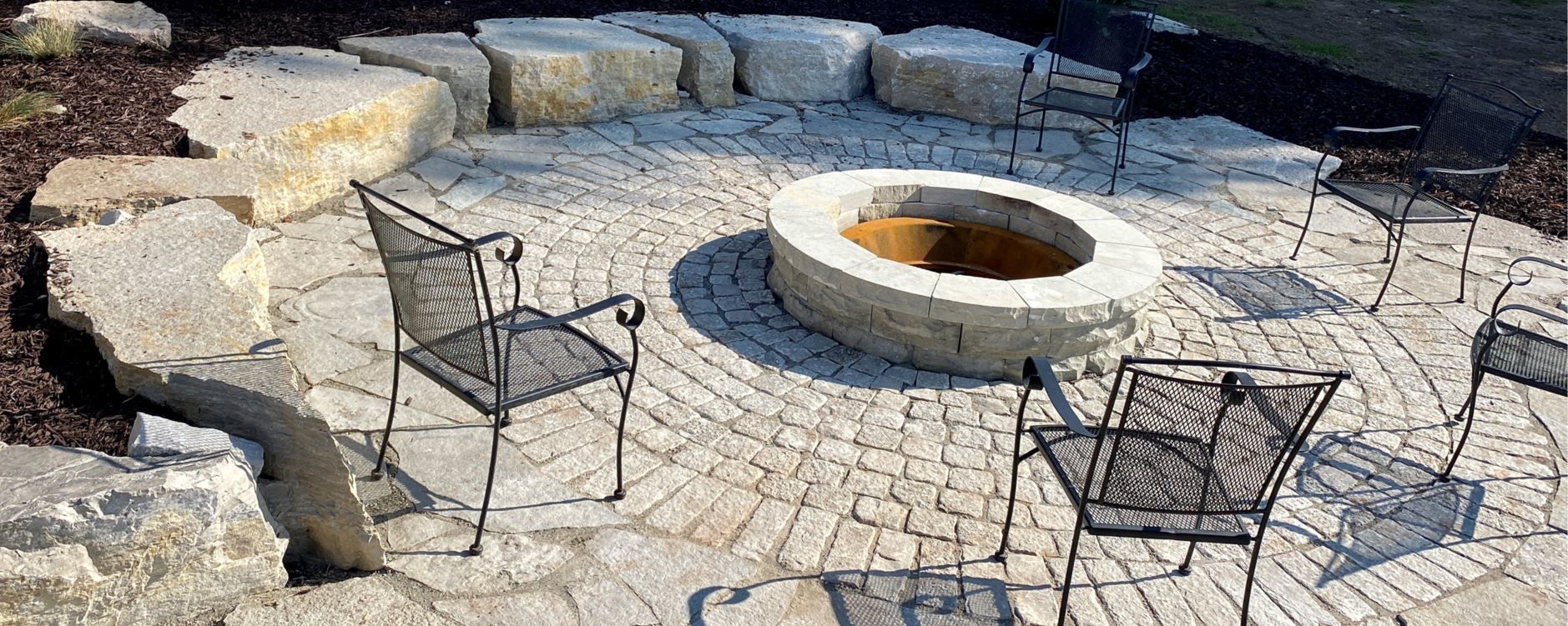 A Fire Pit On A Patio With Chairs Around It — Menasha, WI — Artscapes COC