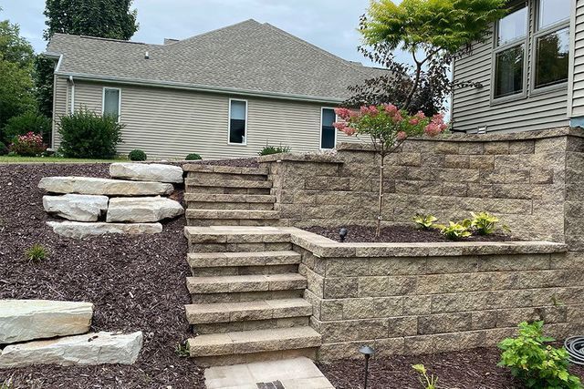 A Stone Wall With Stairs Leading Up To A House — Menasha, WI — Artscapes COC