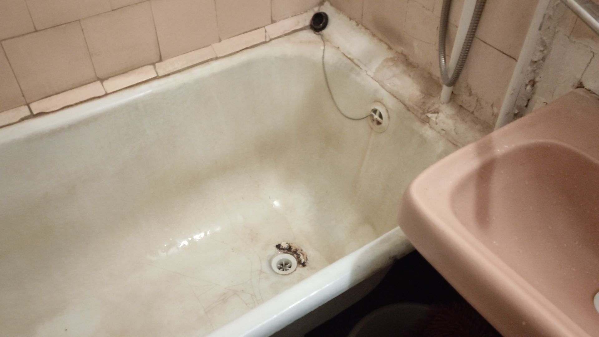 A bathroom with a bathtub and a sink.