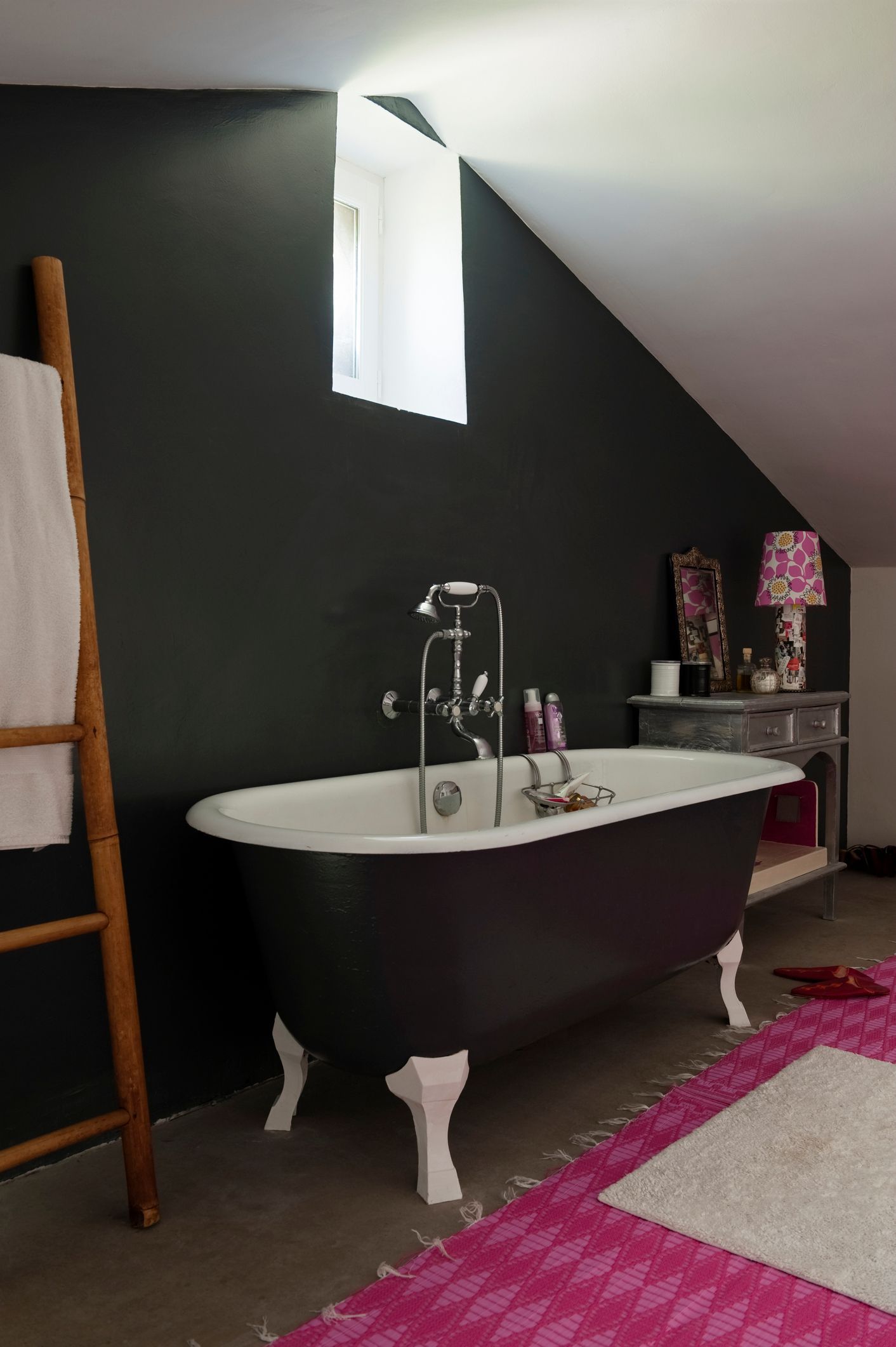 A bathroom with a bathtub and a ladder