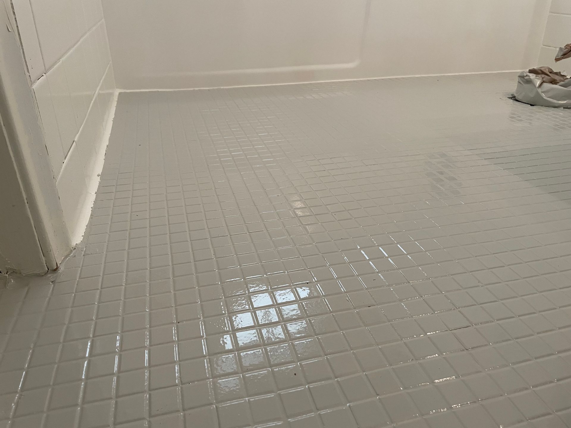 A bathtub is sitting on a tiled floor in a bathroom next to a radiator.