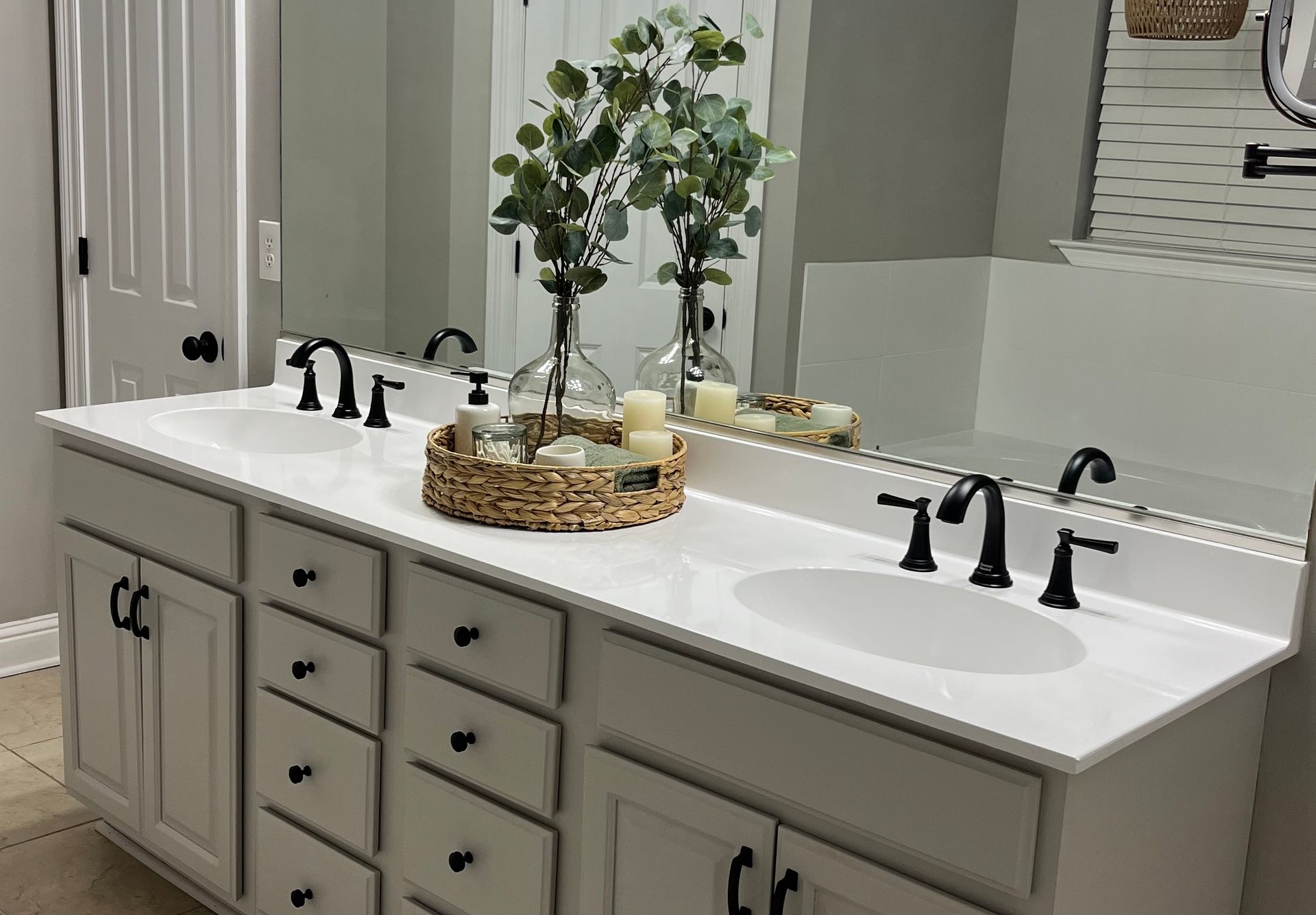 A kitchen with a black sink and a black faucet.