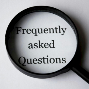 Magnifying glass over the words “Frequently asked Questions” on a white background