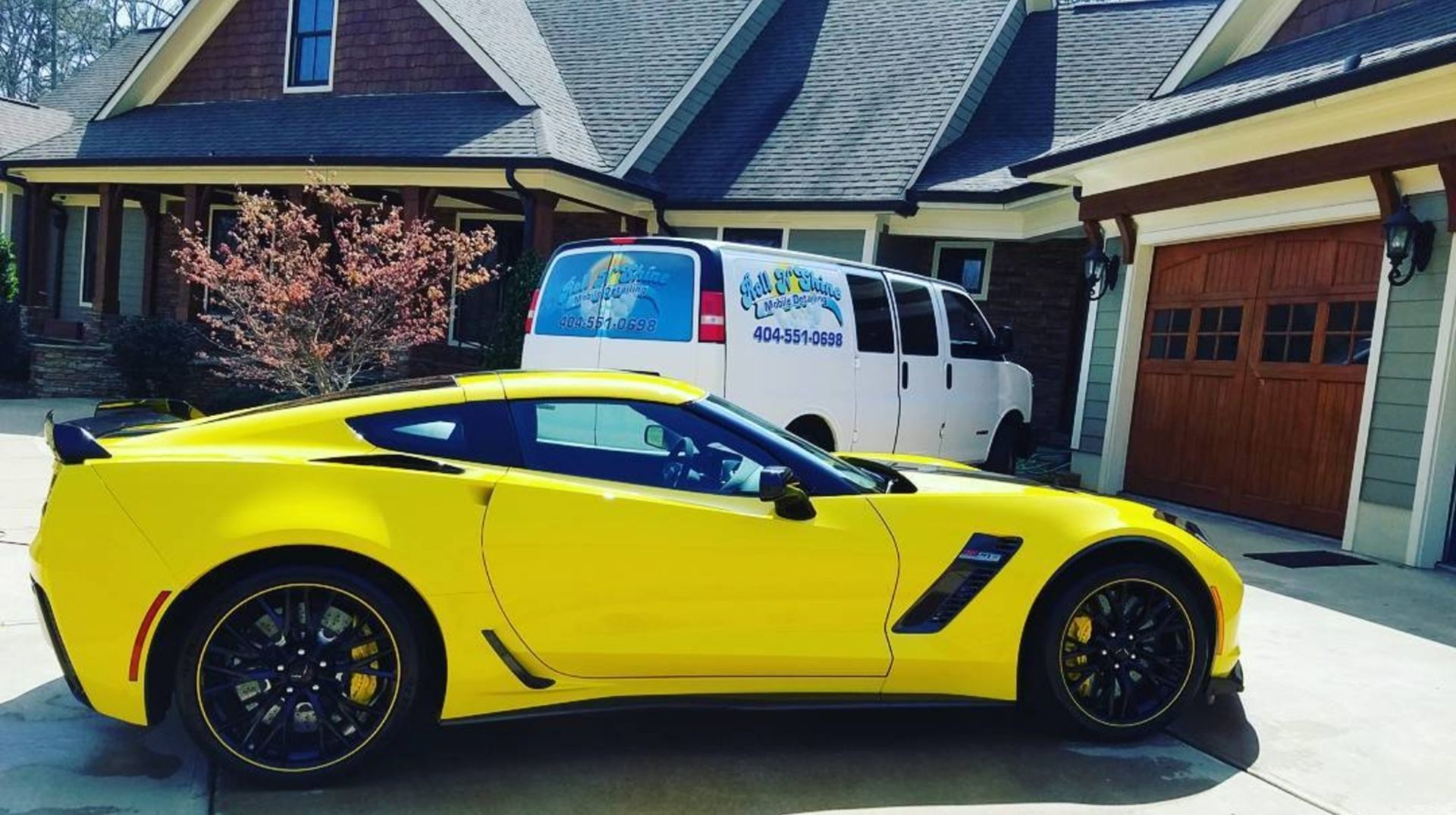 A yellow sports car is parked in front of a house