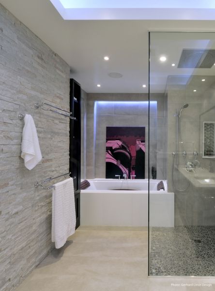 A bathroom with a bathtub and a painting on the wall