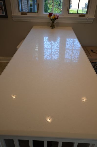 A white table with a vase of flowers on it