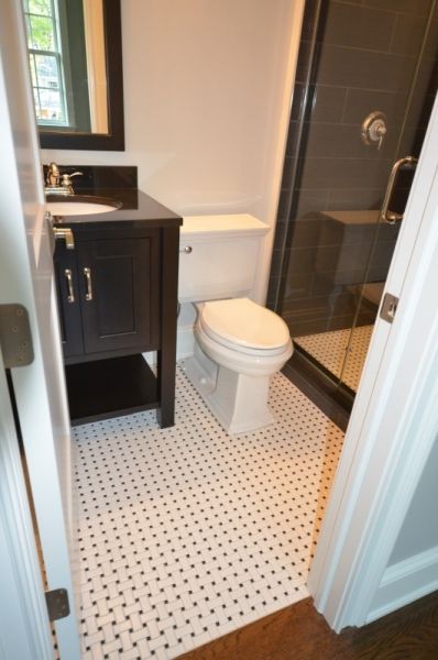 A bathroom with a toilet a sink and a mirror