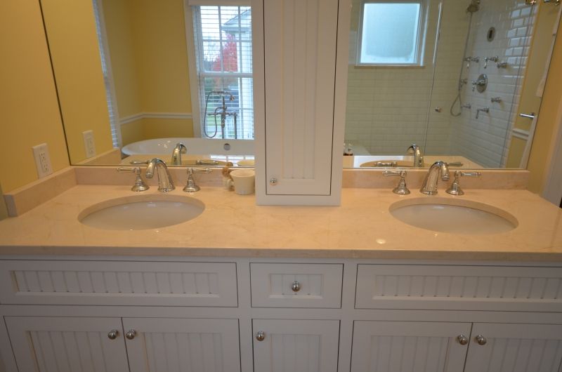 A bathroom with two sinks and a large mirror.