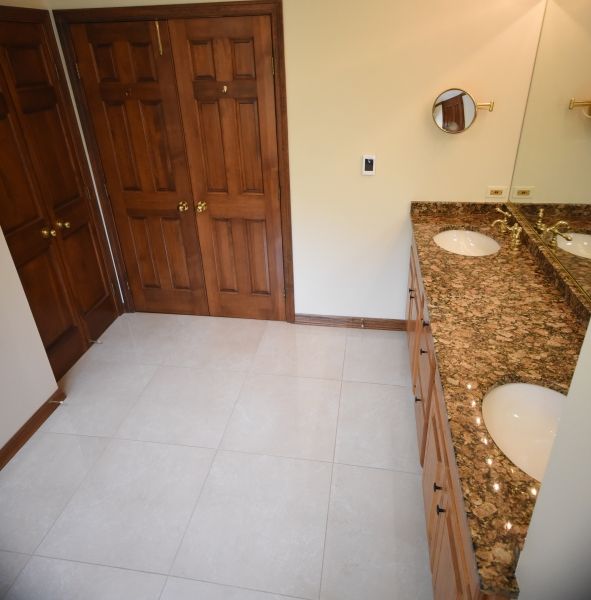 A bathroom with two sinks and a mirror