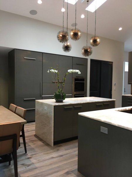 A kitchen with a large island and a dining table