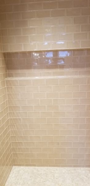 There is a shelf in the shower that looks like a window.