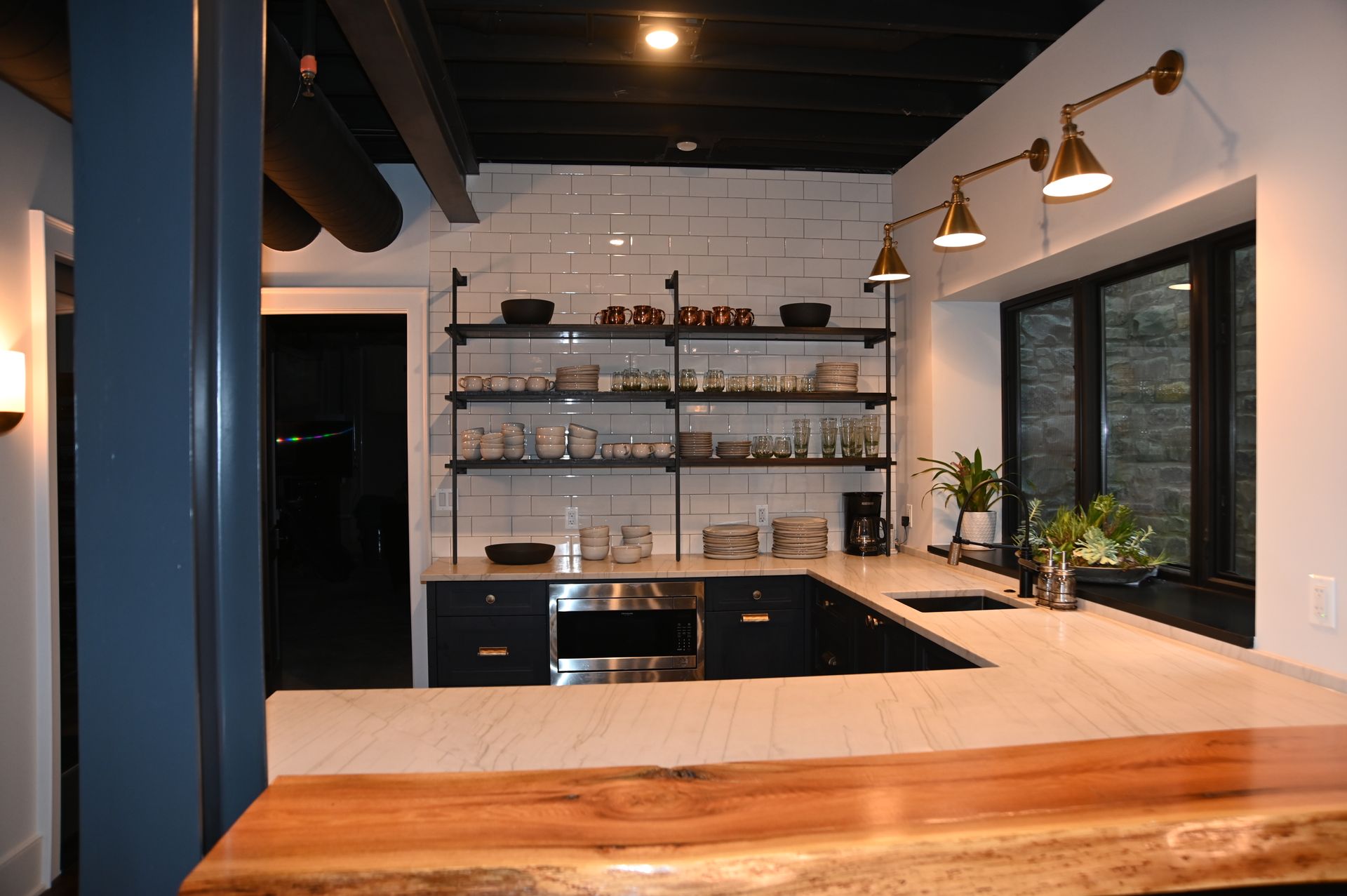 A kitchen with a wooden counter top and stainless steel appliances
