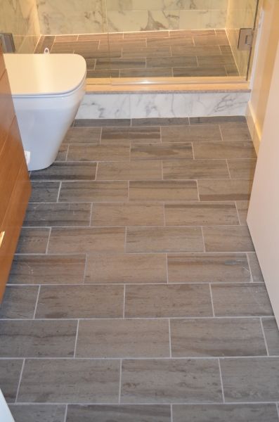 A bathroom with tile floors and a toilet