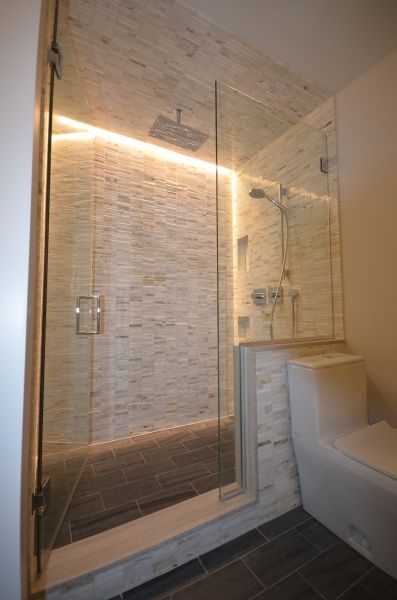 A bathroom with a walk in shower and a toilet