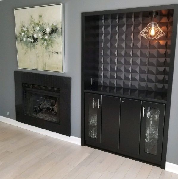A living room with a fireplace and a painting on the wall