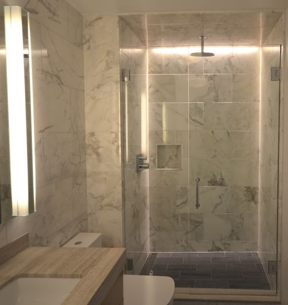 A bathroom with a toilet a sink and a shower