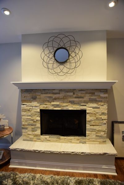 A fireplace with a mirror above it in a living room
