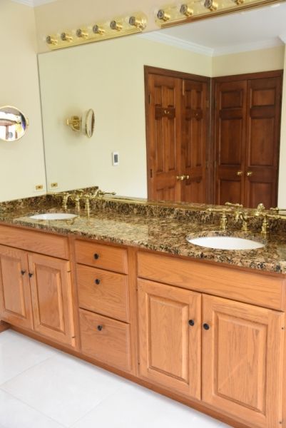 A bathroom with two sinks and a large mirror