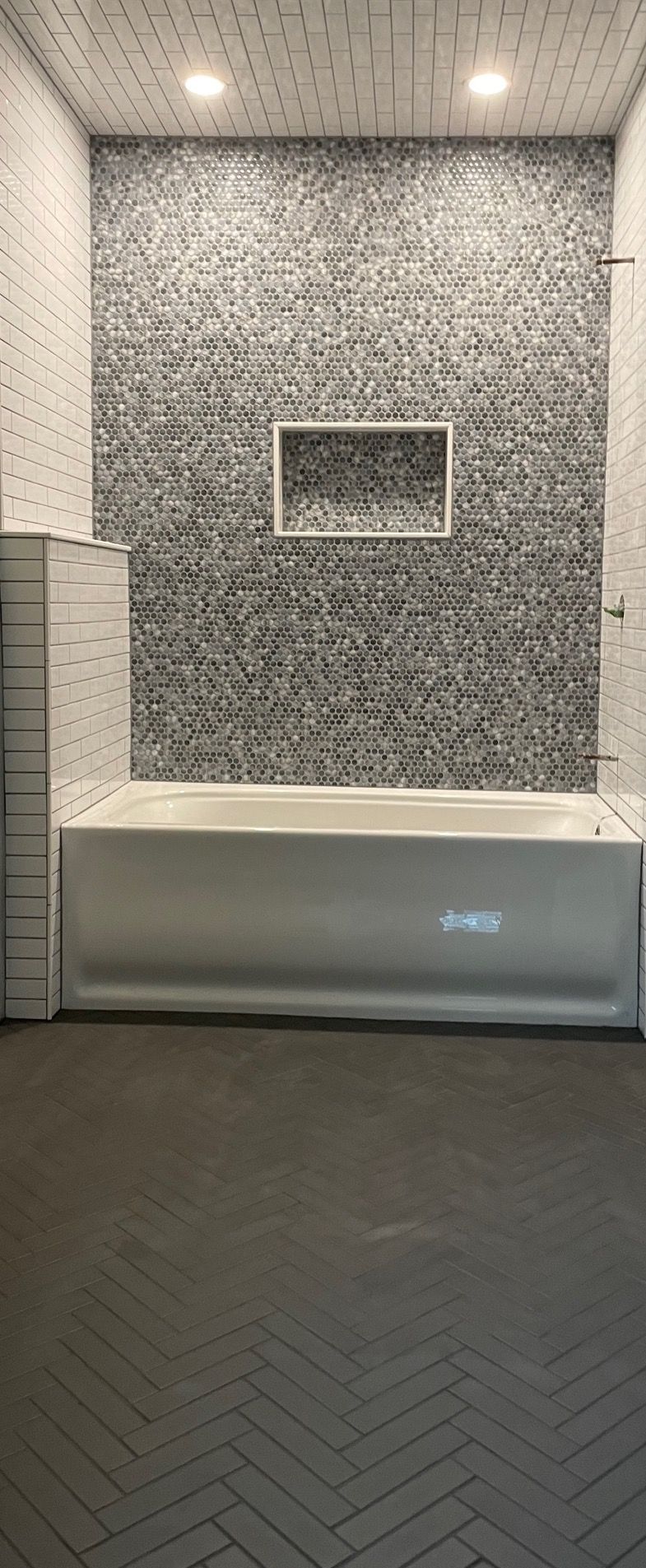 A bathroom with a bathtub and a shower.