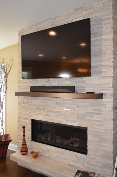 A fireplace with a flat screen tv above it