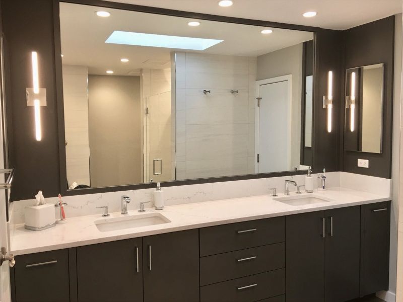 A bathroom with two sinks and a large mirror