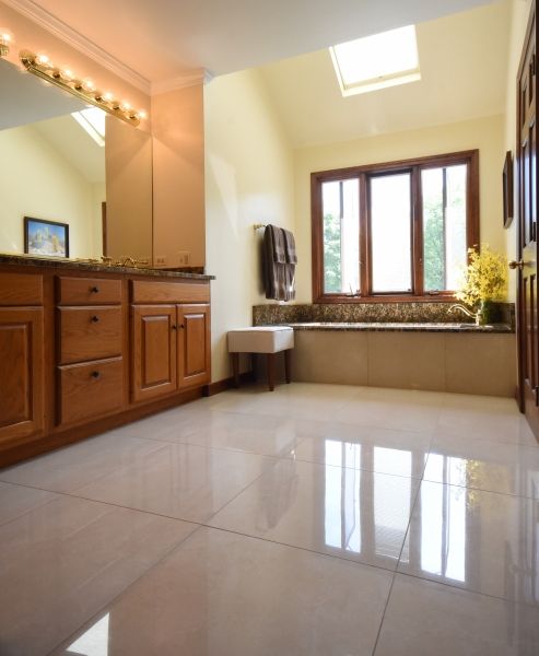 A bathroom with wooden cabinets and a large window
