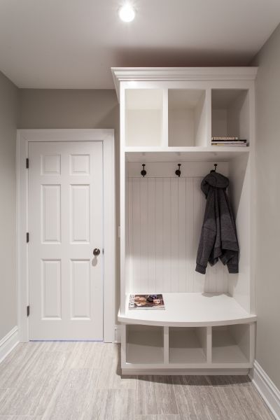 A coat is hanging on a hook in a hallway next to a door