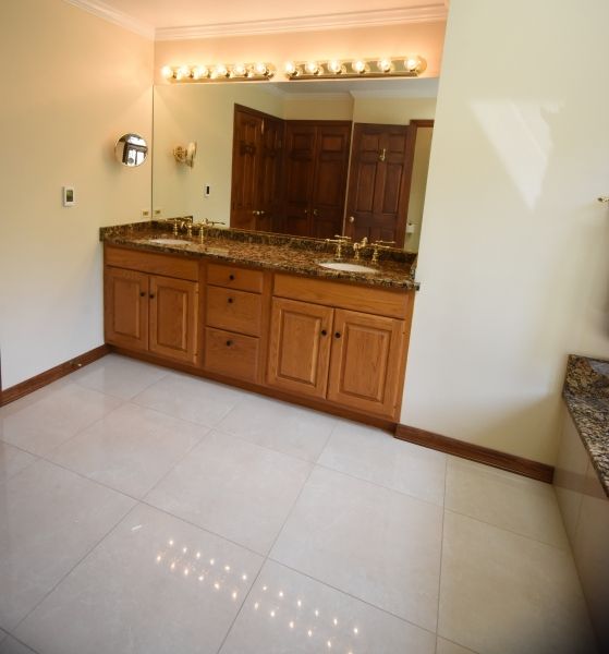 A bathroom with two sinks and a large mirror