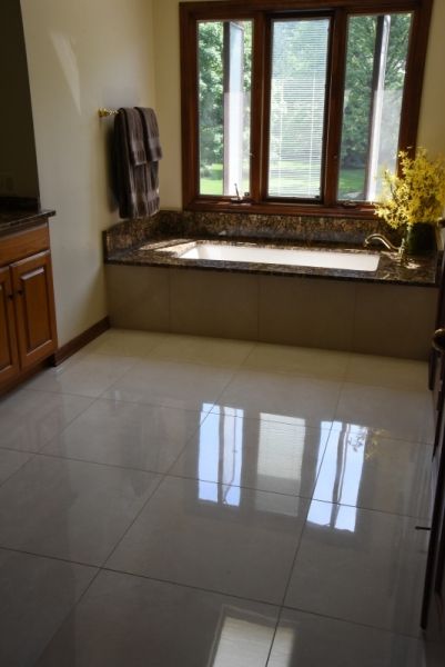A bathroom with a bathtub and a window