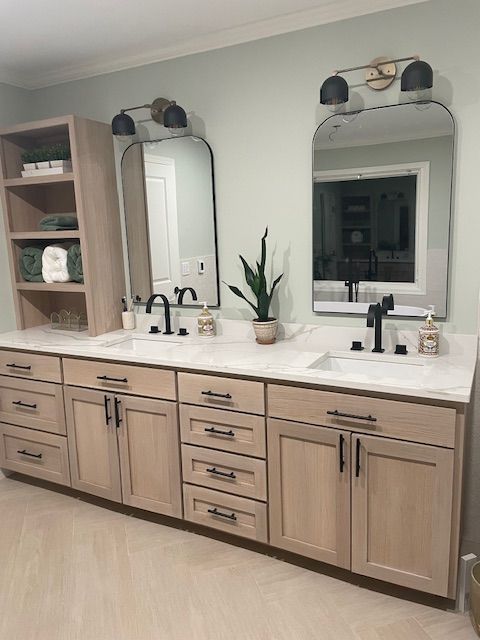 A bathroom with two sinks and two mirrors.