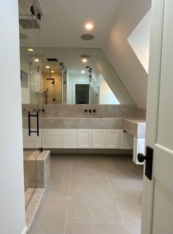 A bathroom with two sinks and a large mirror.