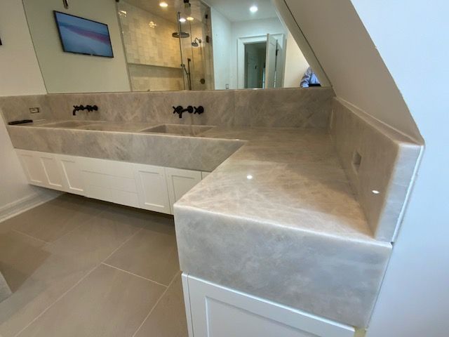 A bathroom with two sinks and a large mirror