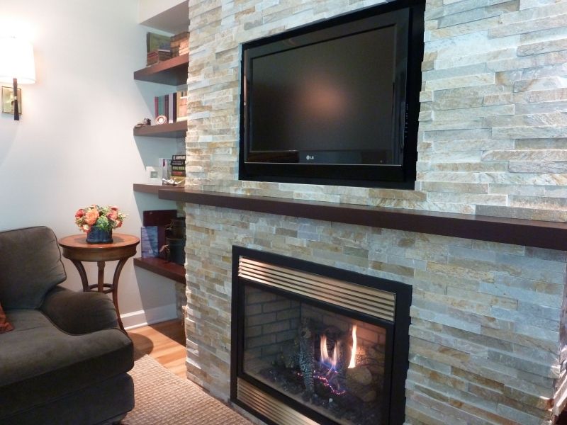 A living room with a fireplace and a flat screen tv