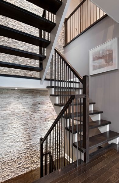 A staircase with a picture on the wall above it