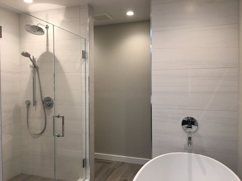 A bathroom with a walk in shower and a bathtub