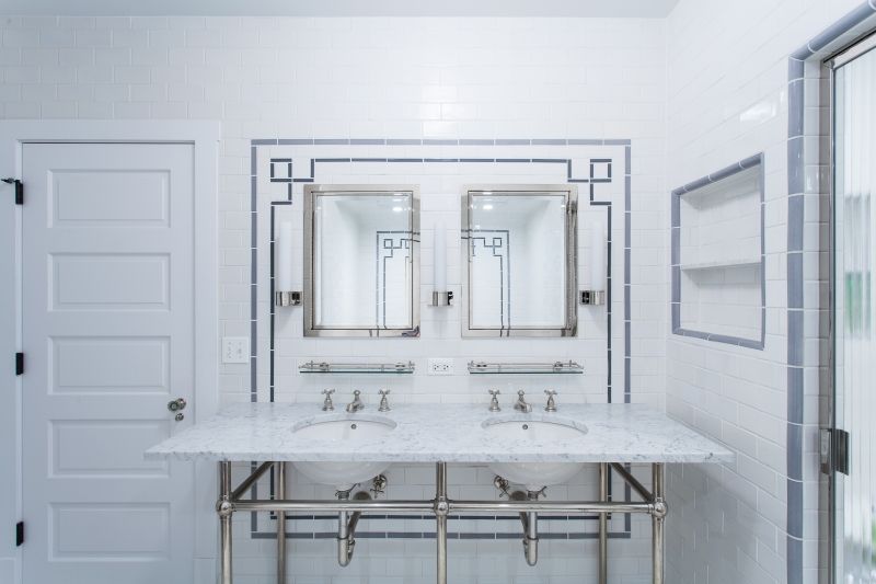 A bathroom with two sinks and two mirrors.