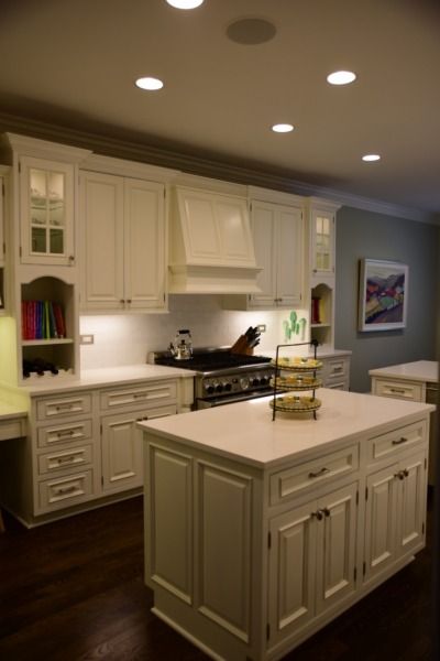A kitchen with white cabinets and a large island