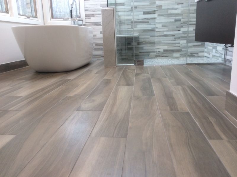 A bathroom with a bathtub and a walk in shower.