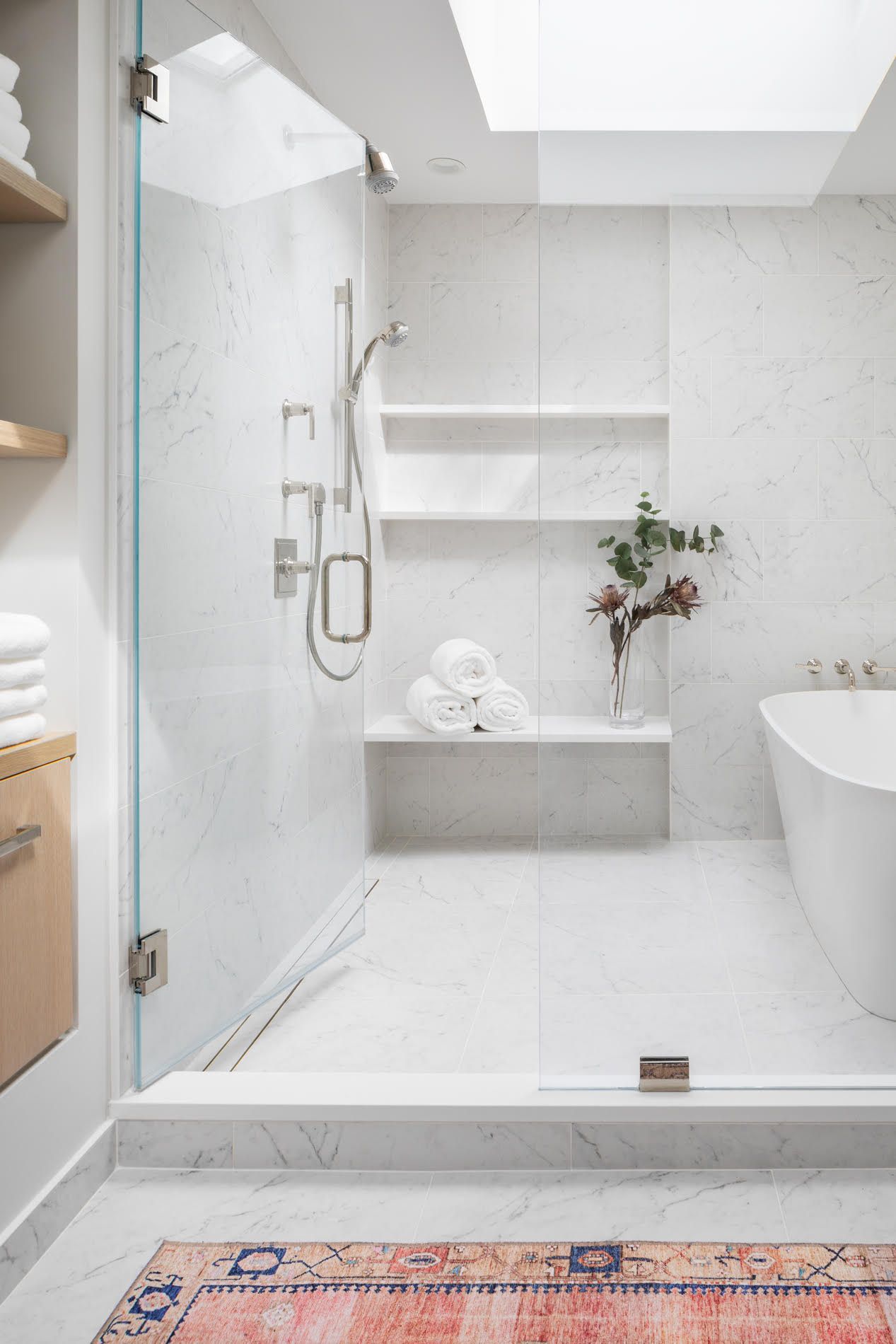 A bathroom with a walk in shower and a bathtub.